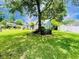 Landscaped yard with a mature tree overlooking a lovely home with white trim and verdant surroundings at 104 Willow Ridge Rd., Myrtle Beach, SC 29588