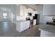 Modern kitchen featuring white cabinets, stainless steel appliances, marble countertops, and light wood flooring at 104 Willow Ridge Rd., Myrtle Beach, SC 29588