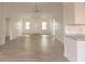 Bright living room with light wood flooring, white walls, a ceiling fan, and natural light at 104 Willow Ridge Rd., Myrtle Beach, SC 29588