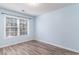 Bright bedroom with light blue walls and wood-look flooring at 107 Maddux Ln. # E, Myrtle Beach, SC 29588