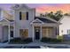 Two-story townhome with neutral siding and landscaping at 107 Maddux Ln. # E, Myrtle Beach, SC 29588