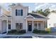 Two-story townhome with neutral siding and landscaping at 107 Maddux Ln. # E, Myrtle Beach, SC 29588
