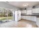 Eat-in kitchen with white cabinets and sliding glass door at 107 Maddux Ln. # E, Myrtle Beach, SC 29588