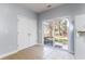 Kitchen with white cabinets, tile floor, and sliding door to patio at 107 Maddux Ln. # E, Myrtle Beach, SC 29588