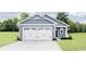 Charming single-story home features a two-car garage, blue siding, and a well-manicured lawn at 1080 Oak Meadow Dr., Conway, SC 29526