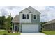 Two-story house with gray siding, white accents, and a two-car garage at 1119 Black Lake Way, Conway, SC 29526