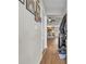 Inviting hallway with hardwood floors leading to a kitchen area, decorated with Gathering photos at 1240 Pineridge St., Conway, SC 29527