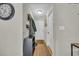 Well-lit hallway with hardwood floors, coat rack, and shelving for convenient storage solutions at 1240 Pineridge St., Conway, SC 29527