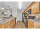 Well-equipped kitchen with laminate countertops, black appliances, and modern lighting fixtures at 1240 Pineridge St., Conway, SC 29527