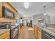 Bright kitchen features wooden cabinets, black appliances, and an open layout, perfect for entertaining at 1240 Pineridge St., Conway, SC 29527