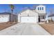 Two-story house with a white garage door and landscaping at 136 Timber Oaks Dr., Myrtle Beach, SC 29588
