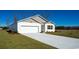 Newly built home with a white exterior, two-car garage, and a neatly landscaped yard at 1443 Porchfield Dr., Conway, SC 29526