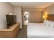King size bed, dresser, and TV in spacious condo bedroom at 1501 S Ocean Blvd. # 1542, Myrtle Beach, SC 29577