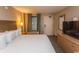King size bed, dresser, TV, and balcony access in condo bedroom at 1501 S Ocean Blvd. # 1542, Myrtle Beach, SC 29577