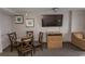 Small dining area with table and four chairs, TV and dresser at 1501 S Ocean Blvd. # 1542, Myrtle Beach, SC 29577
