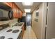 Clean condo kitchen with white appliances and wood cabinets at 1501 S Ocean Blvd. # 1542, Myrtle Beach, SC 29577