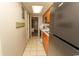 Condo kitchen with wood cabinets, appliances, and bedroom view at 1501 S Ocean Blvd. # 1542, Myrtle Beach, SC 29577