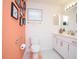 Bathroom with orange accent wall and white cabinets at 160 Stonegate Blvd. # 160, Murrells Inlet, SC 29576