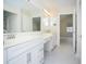 Bright bathroom with double vanity, large mirrors, and doorways to the bedroom and shower area at 160 Stonegate Blvd. # 160, Murrells Inlet, SC 29576