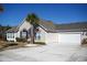 Charming home with stone accents, a two-car garage, palm tree, and a wide driveway at 160 Stonegate Blvd. # 160, Murrells Inlet, SC 29576
