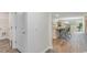 Hallway view of kitchen and laundry room with light wood floors at 201 Jeff Waters Circle, Longs, SC 29568