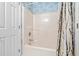 Bathroom with shower/tub combination and neutral-patterned shower curtain with white door at 2022 N Waccamaw Dr., Garden City Beach, SC 29576