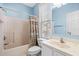 Bathroom with shower/tub combination, white cabinets, and light-blue walls at 2022 N Waccamaw Dr., Garden City Beach, SC 29576