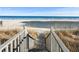 Beach access from the deck with stairs leading down to the sandy shore and ocean view at 2022 N Waccamaw Dr., Garden City Beach, SC 29576
