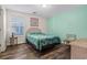Cozy bedroom with tropical bedding, wicker headboard, and a large window at 2022 N Waccamaw Dr., Garden City Beach, SC 29576