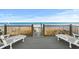 Deck with Adirondack chairs overlooking the beach and the ocean at 2022 N Waccamaw Dr., Garden City Beach, SC 29576