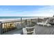 Deck with Adirondack chairs and a view of the beach and ocean at 2022 N Waccamaw Dr., Garden City Beach, SC 29576