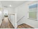 Hallway with wood floors, a window with light coming through, and white walls at 2022 N Waccamaw Dr., Garden City Beach, SC 29576