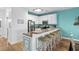 Kitchen bar area featuring seating for five, white cabinetry, stainless refrigerator and tile countertops at 2022 N Waccamaw Dr., Garden City Beach, SC 29576