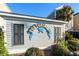 Portofino II sign displayed on a building surrounded by lush greenery and black shutters at 2022 N Waccamaw Dr., Garden City Beach, SC 29576