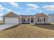 Newly constructed craftsman style home with attached garage and landscaped lawn at 207 Six Mile Creek Dr., Georgetown, SC 29440