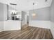 Open concept dining area with hardwood floors and stylish light fixtures at 209 Wando River Rd. # 10C, Myrtle Beach, SC 29579