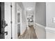 Bright hallway with laminate wood floors and access to bedrooms and bathrooms at 209 Wando River Rd. # 10C, Myrtle Beach, SC 29579
