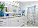 Bathroom with granite countertop, white cabinets, and shower/tub combo at 2225 Essex Dr. # F, Surfside Beach, SC 29575