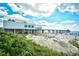 Beach walkway to sandy shore with ocean views and umbrellas at 2225 Essex Dr. # F, Surfside Beach, SC 29575