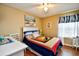 Bedroom with a white dresser, ceiling fan, and patriotic bedding at 2225 Essex Dr. # F, Surfside Beach, SC 29575
