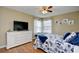 Cozy bedroom with a white dresser, ceiling fan, and nautical bedding at 2225 Essex Dr. # F, Surfside Beach, SC 29575