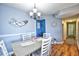 Bright dining area with table and chairs, hardwood floors, and coastal decor at 2225 Essex Dr. # F, Surfside Beach, SC 29575