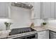 Close up of an electric cooktop in a bright modern kitchen with white subway tile backsplash and gray granite countertops at 226 9Th Ave. S, North Myrtle Beach, SC 29582