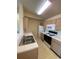 Galley kitchen with white cabinets and appliances at 2276 Essex Dr. # K, Surfside Beach, SC 29575