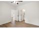 A bedroom boasts wood-look flooring, white walls, and white doors leading to a bathroom and another room at 2428 Park St., North Myrtle Beach, SC 29582
