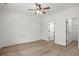 Bright bedroom features paneled accent wall, ceiling fan, and wood-look flooring at 2428 Park St., North Myrtle Beach, SC 29582