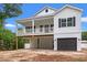 Charming two-story home with a spacious porch and a convenient ground-level garage at 2428 Park St., North Myrtle Beach, SC 29582