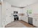 Bright kitchen with white cabinets, stainless steel appliances and hardwood floors at 2428 Park St., North Myrtle Beach, SC 29582