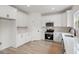 Bright kitchen with white cabinets, stainless steel appliances and hardwood floors at 2428 Park St., North Myrtle Beach, SC 29582