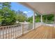 Covered porch with wooden flooring and white railing overlooking neighborhood at 2428 Park St., North Myrtle Beach, SC 29582